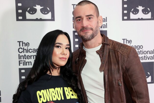 CHICAGO, ILLINOIS - OCTOBER 18: AJ Mendez and  Phil 'CM Punk' Brooks attend the red carpet Premiere of