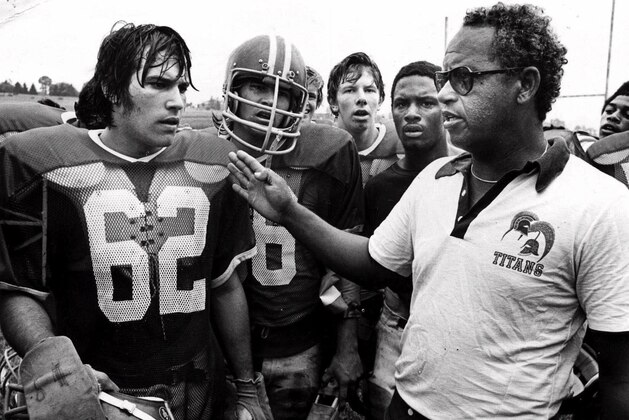 Alexandria, Va's., T.C. Williams High School football coach Herman Boone, right, during a break at summer camp, in 1971, with guard Johnny Colantuoni, (62) and John Vaughn, center. The famous 1971 team will be memorialized by Denzel Washington and Disney films in