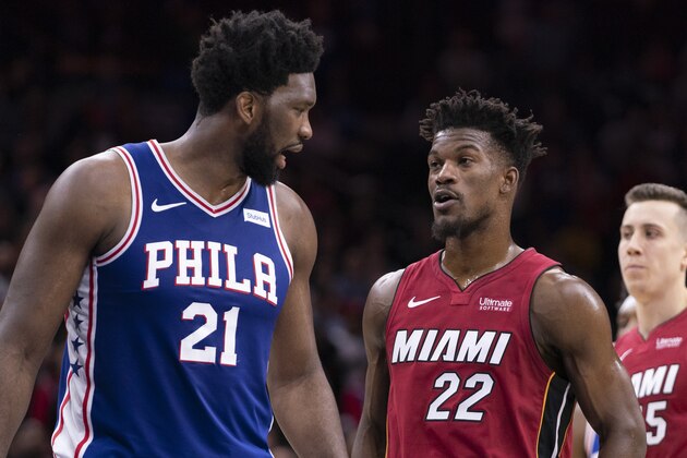 PHILADELPHIA, PA - DECEMBER 18: Joel Embiid #21 of the Philadelphia 76ers talks to Jimmy Butler #22 of the Miami Heat in the fourth quarter at the Wells Fargo Center on December 18, 2019 in Philadelphia, Pennsylvania. The Heat defeated the 76ers 108-104. NOTE TO USER: User expressly acknowledges and agrees that, by downloading and/or using this photograph, user is consenting to the terms and conditions of the Getty Images License Agreement. (Photo by Mitchell Leff/Getty Images)