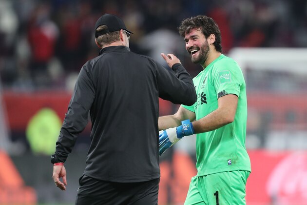 Liverpool's German manager Jurgen Klopp (L) speaks with Liverpool's Brazilian goalkeeper Alisson Becker following the 2019 FIFA Club World Cup semi-final football match between Mexico's Monterrey and England's Liverpool at the Khalifa International Stadium in the Qatari capital Doha on December 18, 2019. - Liverpool will face Flamengo in the Final of the FIFA Club World Cup on December 21. (Photo by KARIM JAAFAR / AFP) (Photo by KARIM JAAFAR/AFP via Getty Images)
