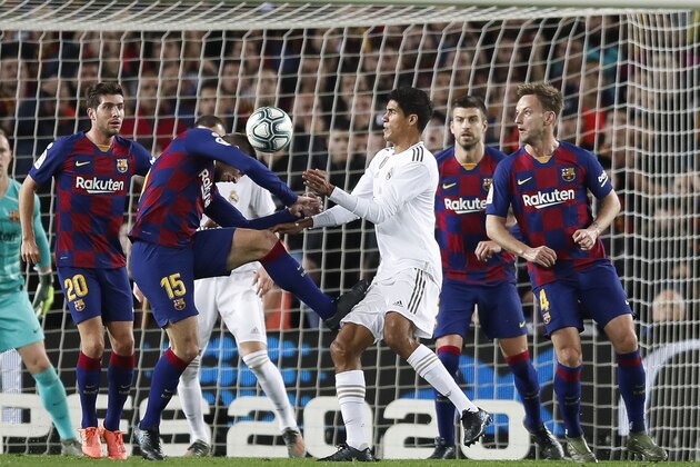 BARCELONA, SPAIN - DECEMBER 18: Clement Lenglet of FC Barcelona challenges against Raphael Varane of Real Madrid during the Liga match between FC Barcelona and Real Madrid CF at Camp Nou on December 18, 2019 in Barcelona, Spain. (Photo by Eric Alonso/Getty Images)