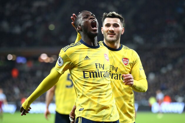 LONDON, ENGLAND - DECEMBER 09: Nicolas Pepe of Arsenal celebrates after scoring his sides second goal with Saed Kolasinac during the Premier League match between West Ham United and Arsenal FC at London Stadium on December 09, 2019 in London, United Kingdom. (Photo by Julian Finney/Getty Images) LONDON, ENGLAND - DECEMBER 09: Nicolas Pepe of Arsenal celebrates after scoring his sides second goal with Saed Kolasinac during the Premier League match between West Ham United and Arsenal FC at London Stadium on December 09, 2019 in London, United Kingdom. (Photo by Julian Finney/Getty Images)