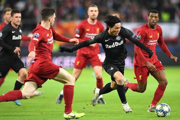 Salzburg's Japanese midfielder Takumi Minamino (c) and Liverpool's Scotland's defender Andrew Robertson (l) vie for the ball during the UEFA Champions League Group E football match between RB Salzburg and Liverpool FC on December 10, 2019 in Salzburg, Austria. (Photo by JOE KLAMAR / AFP) (Photo by JOE KLAMAR/AFP via Getty Images)