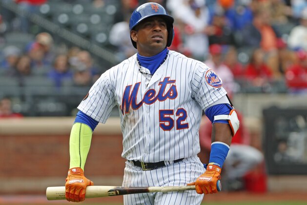 New York Mets Yoenis Cespedes (52) holds his broken bat as he looks at a video replay of his flyout to deep left field during the third inning of a baseball game against the St. Louis Cardinals, Sunday, April 1, 2018, in New York. (AP Photo/Kathy Willens)