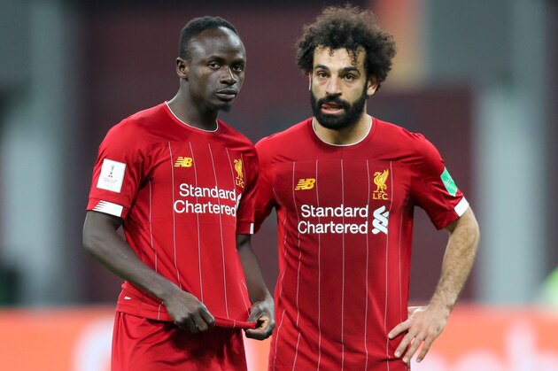Liverpool's Senegalese striker Sadio Mane (L) speaks with Liverpool's Egyptian midfielder Mohamed Salah during the 2019 FIFA Club World Cup semi-final football match between Mexico's Monterrey and England's Liverpool at the Khalifa International Stadium in the Qatari capital Doha on December 18, 2019. (Photo by KARIM JAAFAR / AFP) (Photo by KARIM JAAFAR/AFP via Getty Images)