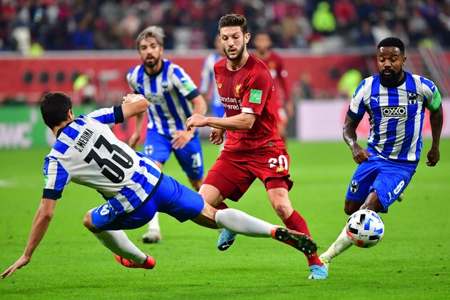 Liverpool's English midfielder Adam Lallana (C) passes the ball as he is marked by Monterrey's defender Stefan Medina during the 2019 FIFA Club World Cup semi-final football match between Mexico's Monterrey and England's Liverpool at the Khalifa International Stadium in the Qatari capital Doha on December 18, 2019. (Photo by Giuseppe CACACE / AFP) (Photo by GIUSEPPE CACACE/AFP via Getty Images)