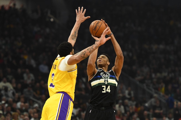 MILWAUKEE, WISCONSIN - DECEMBER 19:  Giannis Antetokounmpo #34 of the Milwaukee Bucks shoots over Anthony Davis #3 of the Los Angeles Lakers during the first half of a game at Fiserv Forum on December 19, 2019 in Milwaukee, Wisconsin. NOTE TO USER: User expressly acknowledges and agrees that, by downloading and or using this photograph, User is consenting to the terms and conditions of the Getty Images License Agreement. (Photo by Stacy Revere/Getty Images)