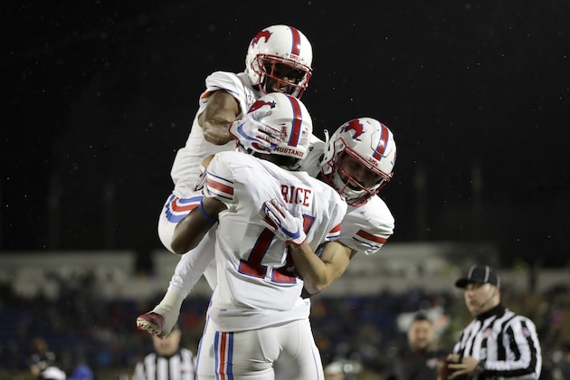 SMU wide receiver James Proche, left, and wide receiver Tyler Page, right, celebrate with wide receiver Rashee Rice after he caught a touchdown pass from quarterback Shane Buechele during the second half of an NCAA college football game against Navy, Saturday, Nov. 23, 2019, in Annapolis, Md. Navy won 35-28. (AP Photo/Julio Cortez)