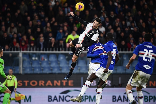 TOPSHOT - Juventus' Portuguese forward Cristiano Ronaldo (C) scores a header during the Italian Serie A football match Sampdoria vs Juventus on December 18, 2019 at the Luigi-Ferraris stadium in Genoa. (Photo by Marco Bertorello / AFP) (Photo by MARCO BERTORELLO/AFP via Getty Images)