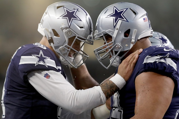 ARLINGTON, TEXAS - DECEMBER 15: Dak Prescott #4 of the Dallas Cowboys celebrates with La'el Collins #71 of the Dallas Cowboys after the Dallas Cowboys scored a touchdown  against the Los Angeles Rams in the second quarter at AT&T Stadium on December 15, 2019 in Arlington, Texas. (Photo by Tom Pennington/Getty Images)