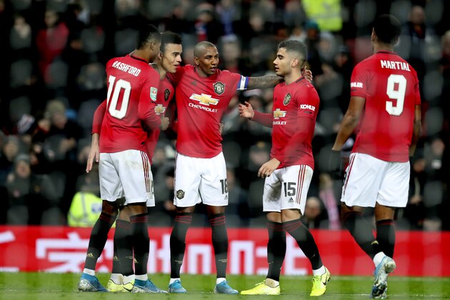 Manchester United's players celebrate after Colchester United's Ryan Jackson, scored an own goal during the English League Cup quarter final soccer match between Manchester United and Colchester United at Old Trafford in Manchester, England, Wednesday, Dec. 18, 2019. (AP Photo/Jon Super)