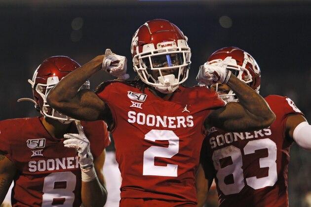 NORMAN, OK - NOVEMBER 9:  Wide receiver CeeDee Lamb #2 of the Oklahoma Sooners celebrates his touchdown on a 63-yard pass and run with wide receivers Trejan Bridges #8 and Nick Basquine #83 in the game against the Iowa State Cyclones on November 9, 2019 at Gaylord Family Oklahoma Memorial Stadium in Norman, Oklahoma. The Sooners lead 35-14 at the half. (Photo by Brian Bahr/Getty Images)