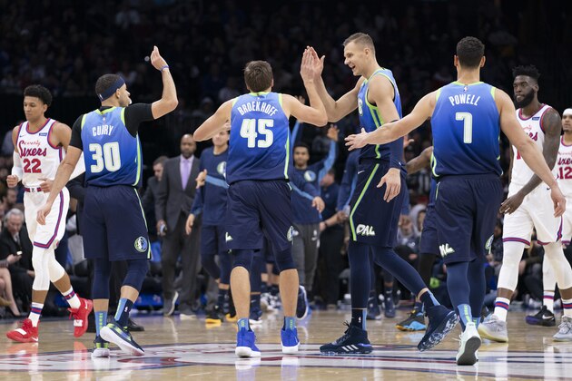 PHILADELPHIA, PA - DECEMBER 20: Seth Curry #30, Ryan Broekhoff #45, Kristaps Porzingis #6, and Dwight Powell #7 of the Dallas Mavericks react in front of Matisse Thybulle #22 and Norvel Pelle #14 of the Philadelphia 76ers in the second quarter at the Wells Fargo Center on December 20, 2019 in Philadelphia, Pennsylvania. NOTE TO USER: User expressly acknowledges and agrees that, by downloading and/or using this photograph, user is consenting to the terms and conditions of the Getty Images License Agreement. (Photo by Mitchell Leff/Getty Images)
