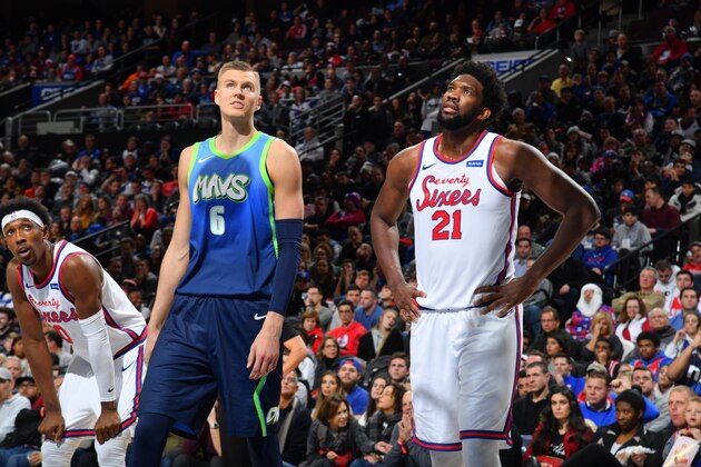 PHILADELPHIA, PA - DECEMBER 20: Kristaps Porzingis #6 of the Dallas Mavericks and Joel Embiid #21 of the Philadelphia 76ers look on during a game on December 20, 2019 at the Wells Fargo Center in Philadelphia, Pennsylvania NOTE TO USER: User expressly acknowledges and agrees that, by downloading and/or using this Photograph, user is consenting to the terms and conditions of the Getty Images License Agreement. Mandatory Copyright Notice: Copyright 2019 NBAE (Photo by Jesse D. Garrabrant/NBAE via Getty Images)