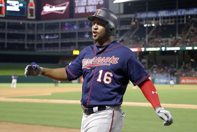 Minnesota Twins' Jonathan Schoop celebrates as he walks up to the dugout after hitting a two-run home run off Texas Rangers' Mike Minor during the seventh inning of a baseball game in Arlington, Texas, Friday, Aug. 16, 2019. The shot scored Marwin Gonzalez. (AP Photo/Tony Gutierrez)
