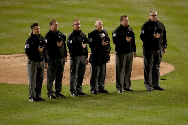 WASHINGTON, DC - OCTOBER 27:  The umpires stand for God Bless America during the seventh inning stretch in Game Five of the 2019 World Series between the Houston Astros and the Washington Nationals at Nationals Park on October 27, 2019 in Washington, DC. (Photo by Win McNamee/Getty Images)