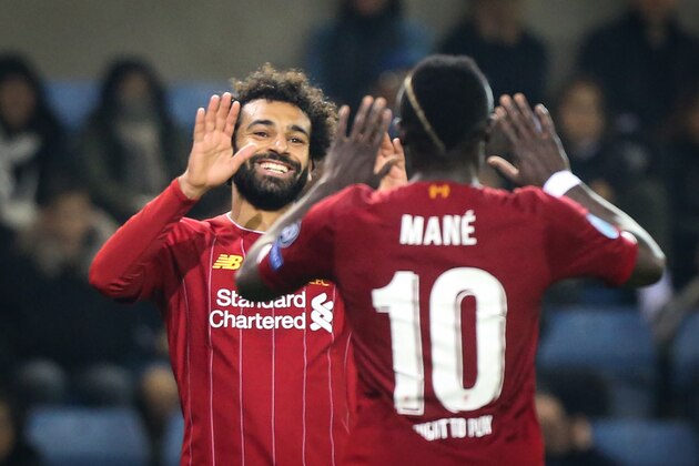TOPSHOT - Liverpool's Egyptian midfielder Mohamed Salah (L) celebrates with Liverpool's Senegalese striker Sadio Mane (R) after scoring a goal during the UEFA Champions League Group E football match between (KRC) Genk and Liverpool on October 23, 2019 at the Luminus Arena in Genk. (Photo by François WALSCHAERTS / AFP) (Photo by FRANCOIS WALSCHAERTS/AFP via Getty Images)