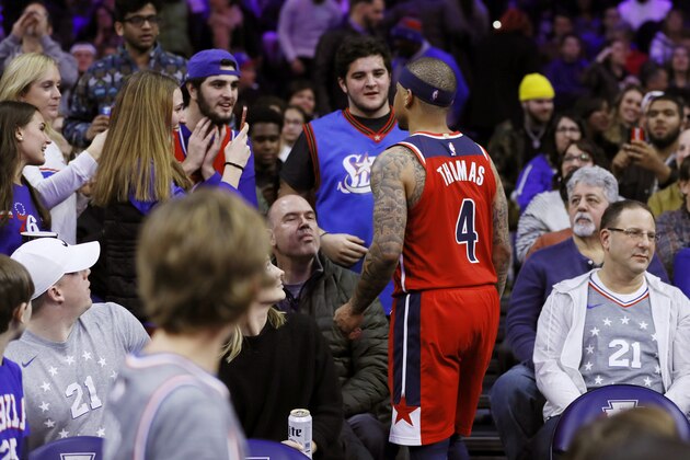Washington Wizards' Isaiah Thomas talks with fans in the stands during the second half of an NBA basketball game against the Philadelphia 76ers, Saturday, Dec. 21, 2019, in Philadelphia. Thomas was ejected from the game after leaving the court. (AP Photo/Matt Slocum)