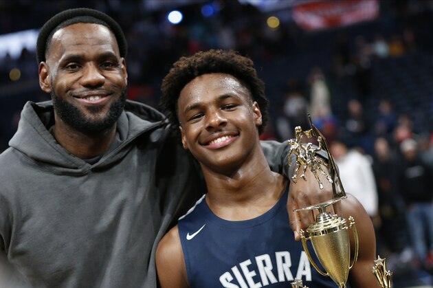 LeBron James, left, poses with his son Bronny after Sierra Canyon beat Akron St. Vincent - St. Mary in a high school basketball game, Saturday, Dec. 14, 2019, in Columbus, Ohio. (AP Photo/Jay LaPrete)