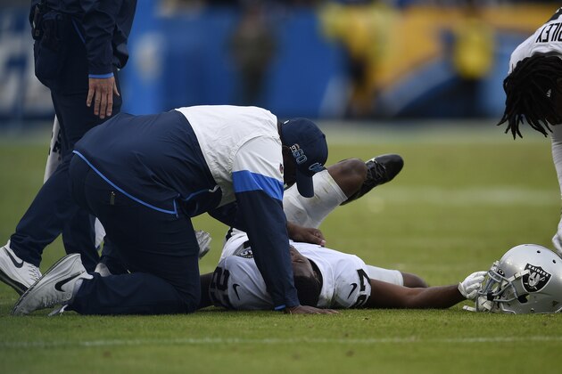 Oakland Raiders cornerback Trayvon Mullen is treated on the field during the second half of an NFL football game against the Los Angeles Chargers Sunday, Dec. 22, 2019, in Carson, Calif. (AP Photo/Kelvin Kuo)
