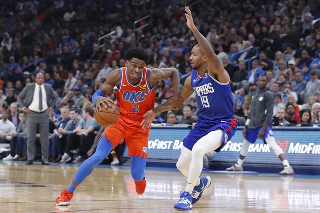Oklahoma City Thunder guard Shai Gilgeous-Alexander (2) drives to the basket around Los Angeles Clippers guard Rodney McGruder (19) during the second quarter of an NBA basketball game Sunday, Dec. 22, 2019, in Oklahoma City. (AP Photo/Alonzo Adams)