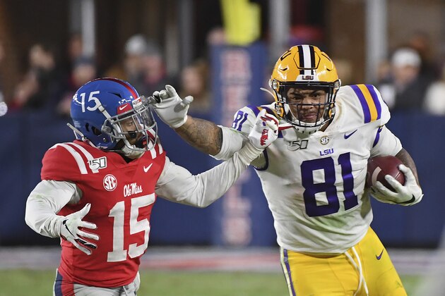 LSU tight end Thaddeus Moss (81) looks for room past Mississippi defensive back Myles Hartsfield (15) during the second half of an NCAA college football game in Oxford, Miss., Saturday, Nov. 16, 2019. No. 1 LSU won 58-37. (AP Photo/Thomas Graning)