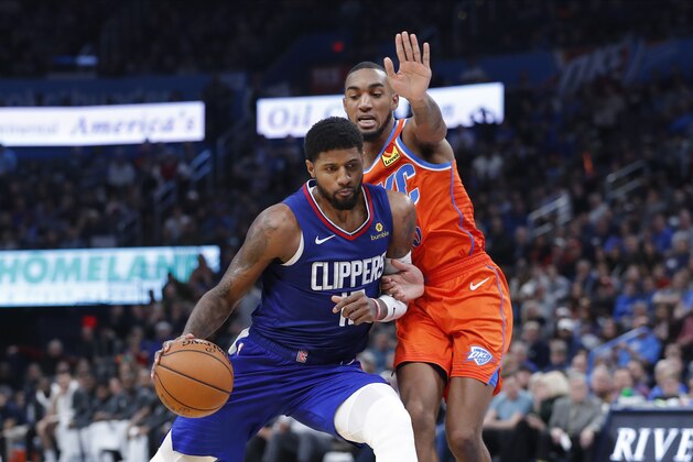 Los Angeles Clippers forward Paul George (13) drives to the basket as Oklahoma City Thunder guard Terrance Ferguson (23) defends during the second half of an NBA basketball game, Sunday, Dec. 22, 2019, in Oklahoma City. Oklahoma City won 118-112. (AP Photo/Alonzo Adams)