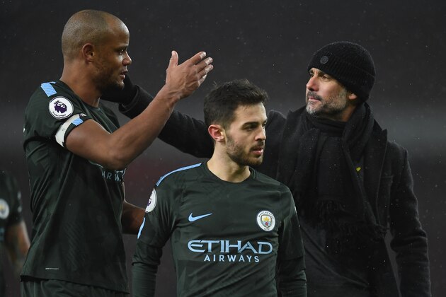 LONDON, ENGLAND - MARCH 01:  Pep Guardiola, manager of Manchester City speaks to Vincent Kompany as Bernando Silva looks on after the Premier League match between Arsenal and Manchester City at Emirates Stadium on March 1, 2018 in London, England.  (Photo by Mike Hewitt/Getty Images)