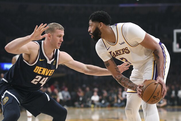 Denver Nuggets center Mason Plumlee, left, and Los Angeles Lakers forward Anthony Davis in action during an NBA basketball game Sunday, Dec. 22, 2019, in Los Angeles. (AP Photo/Michael Owen Baker)