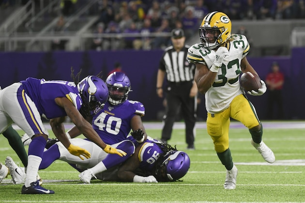 Green Bay Packers running back Aaron Jones (33) carries on a 56-yard touchdown run during the second half of the team's NFL football game against the Minnesota Vikings, Monday, Dec. 23, 2019, in Minneapolis. (AP Photo/Craig Lassig)
