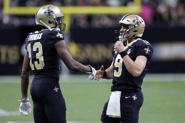 New Orleans Saints quarterback Drew Brees (9) greets New Orleans Saints wide receiver Michael Thomas (13) after a touchdown in the second half of an NFL football game against the Arizona Cardinals in New Orleans, Sunday, Oct. 27, 2019. (AP Photo/Bill Feig)