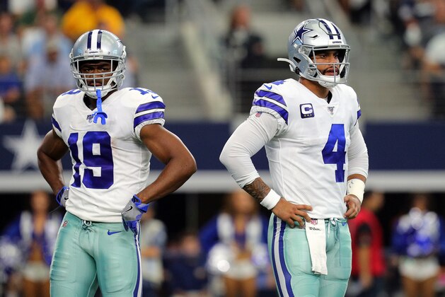 ARLINGTON, TEXAS - OCTOBER 06: Amari Cooper #19 of the Dallas Cowboys and Dak Prescott #4 of the Dallas Cowboys stand on the field in the first quarter against the Green Bay Packers at AT&T Stadium on October 06, 2019 in Arlington, Texas. (Photo by Richard Rodriguez/Getty Images)
