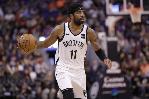 Brooklyn Nets guard Kyrie Irving (11) brings the ball up against the Phoenix Suns during the second half of an NBA basketball game Sunday, Nov. 10, 2019, in Phoenix. (AP Photo/Matt York)