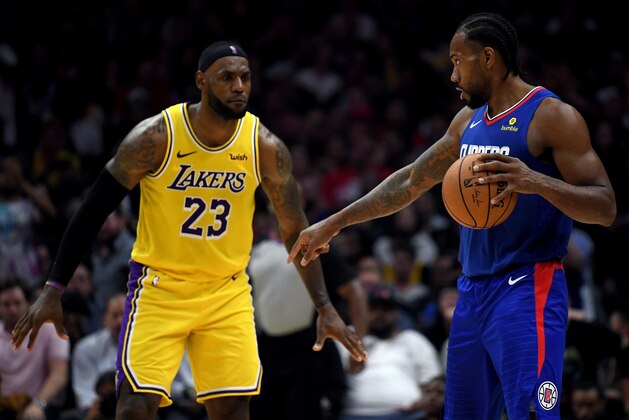 LOS ANGELES, CALIFORNIA - OCTOBER 22:   Kawhi Leonard #2 of the LA Clippers controls possession of the ball in front of LeBron James #23 of the Los Angeles Lakers late in the fourth quarter in a 112-102 Clipper win during the LA Clippers season home opener at Staples Center on October 22, 2019 in Los Angeles, California. (Photo by Harry How/Getty Images)
