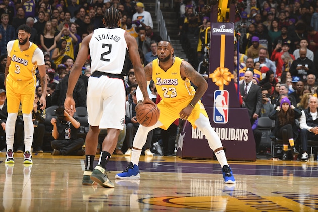 LOS ANGELES, CA - DECEMBER 25: LeBron James #23 of the Los Angeles Lakers plays defense against Kawhi Leonard #2 of the LA Clippers during the game on December 25, 2019 at STAPLES Center in Los Angeles, California. NOTE TO USER: User expressly acknowledges and agrees that, by downloading and/or using this Photograph, user is consenting to the terms and conditions of the Getty Images License Agreement. Mandatory Copyright Notice: Copyright 2019 NBAE (Photo by Andrew D. Bernstein/NBAE via Getty Images)