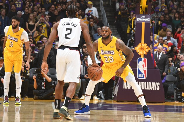 LOS ANGELES, CA - DECEMBER 25: LeBron James #23 of the Los Angeles Lakers plays defense against Kawhi Leonard #2 of the LA Clippers during the game on December 25, 2019 at STAPLES Center in Los Angeles, California. NOTE TO USER: User expressly acknowledges and agrees that, by downloading and/or using this Photograph, user is consenting to the terms and conditions of the Getty Images License Agreement. Mandatory Copyright Notice: Copyright 2019 NBAE (Photo by Andrew D. Bernstein/NBAE via Getty Images)
