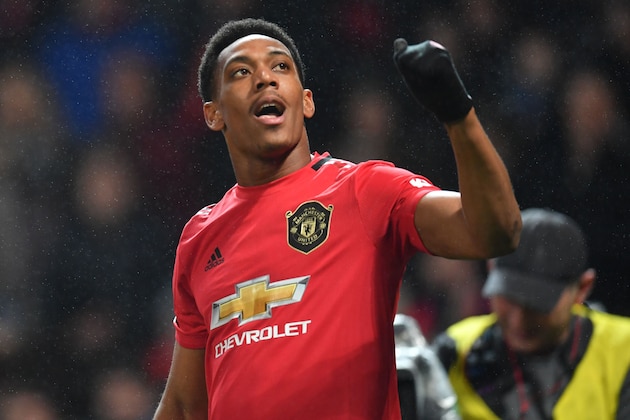 Manchester United's French striker Anthony Martial celebrates after scoring his second goal, the team's fourth during the English Premier League football match between Manchester United and Newcastle United at Old Trafford in Manchester, north west England, on December 26, 2019. (Photo by Paul ELLIS / AFP) / RESTRICTED TO EDITORIAL USE. No use with unauthorized audio, video, data, fixture lists, club/league logos or 'live' services. Online in-match use limited to 120 images. An additional 40 images may be used in extra time. No video emulation. Social media in-match use limited to 120 images. An additional 40 images may be used in extra time. No use in betting publications, games or single club/league/player publications. /  (Photo by PAUL ELLIS/AFP via Getty Images)