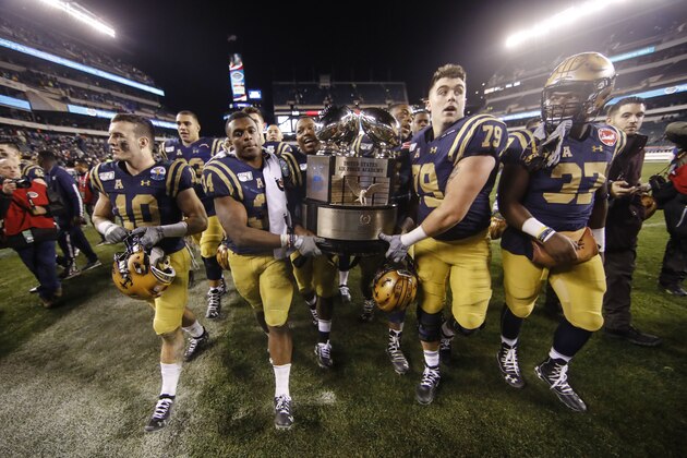 Navy midshipmen carrie off the Commander in Chief's trophy after defeating Army in an NCAA college football game, Saturday, Dec. 14, 2019, in Philadelphia. Navy won 31-7. (AP Photo/Matt Rourke)