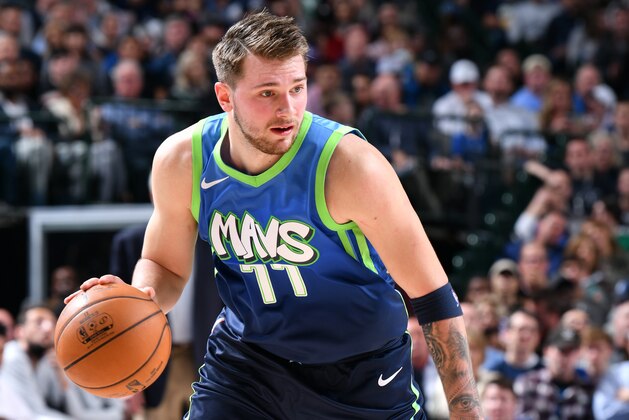 DALLAS, TX - DECEMBER 26: Luka Doncic #77 of the Dallas Mavericks drives to the basket against the San Antonio Spurs on December 26, 2019 at the American Airlines Center in Dallas, Texas. NOTE TO USER: User expressly acknowledges and agrees that, by downloading and or using this photograph, User is consenting to the terms and conditions of the Getty Images License Agreement. Mandatory Copyright Notice: Copyright 2019 NBAE (Photo by Glenn James/NBAE via Getty Images)