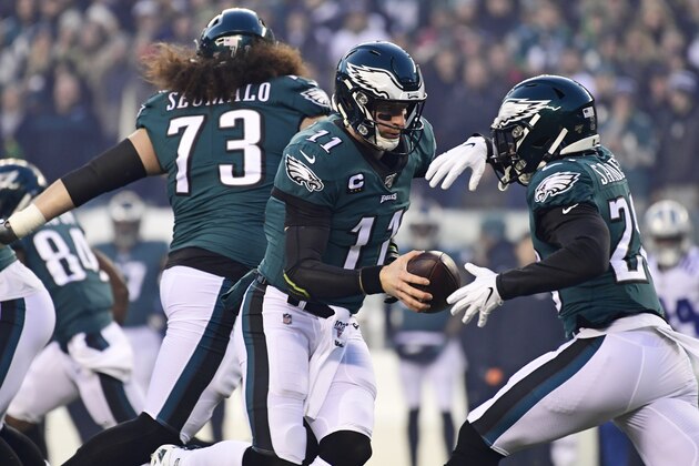 PHILADELPHIA, PA - DECEMBER 22: Carson Wentz #11 of the Philadelphia Eagles hands off to teammate Miles Sanders #26 during the first quarter at Lincoln Financial Field on December 22, 2019 in Philadelphia, Pennsylvania. The Philadelphia Eagles defeated the Dallas Cowboys 17-9. (Photo by Corey Perrine/Getty Images)