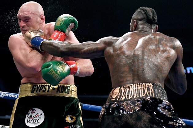 LOS ANGELES, CA - DECEMBER 01:  Deontay Wilder punches Tyson Fury in the fifth round, fighting to a draw during the WBC Heavyweight Championship at Staples Center on December 1, 2018 in Los Angeles, California.  (Photo by Harry How/Getty Images)