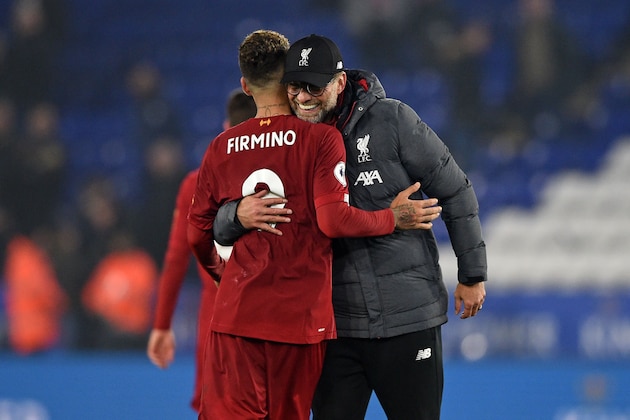 Liverpool's German manager Jurgen Klopp (R) embraces Liverpool's Brazilian midfielder Roberto Firmino (L) as they celebrate on the pitch after the English Premier League football match between Leicester City and Liverpool at King Power Stadium in Leicester, central England on December 26, 2019. - Liverpool won the game 4-0. (Photo by Oli SCARFF / AFP) / RESTRICTED TO EDITORIAL USE. No use with unauthorized audio, video, data, fixture lists, club/league logos or 'live' services. Online in-match use limited to 120 images. An additional 40 images may be used in extra time. No video emulation. Social media in-match use limited to 120 images. An additional 40 images may be used in extra time. No use in betting publications, games or single club/league/player publications. /  (Photo by OLI SCARFF/AFP via Getty Images)