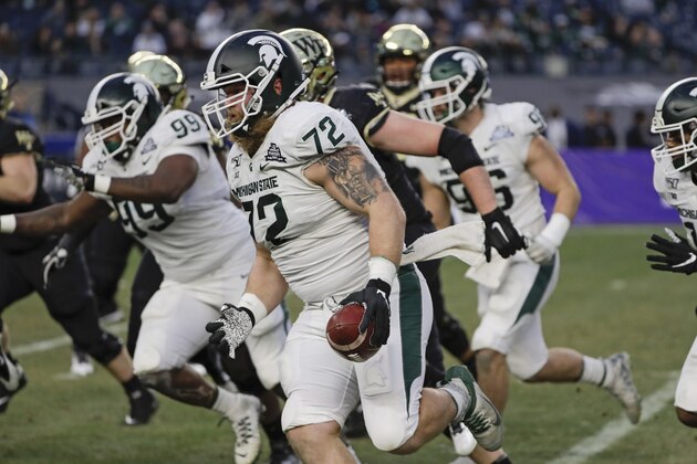 Michigan State's Mike Panasiuk (72) runs back an interception for a touchdown during the first half of the Pinstripe Bowl NCAA college football game against Wake Forest, Friday, Dec. 27, 2019, in New York. (AP Photo/Frank Franklin II)