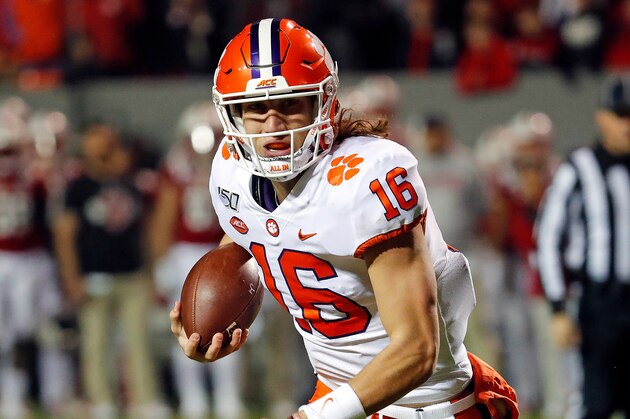 Clemson's Trevor Lawrence (16) scrambles with the ball during the first half of an NCAA college football game against North Carolina State in Raleigh, N.C., Saturday, Nov. 9, 2019. (AP Photo/Karl B DeBlaker)