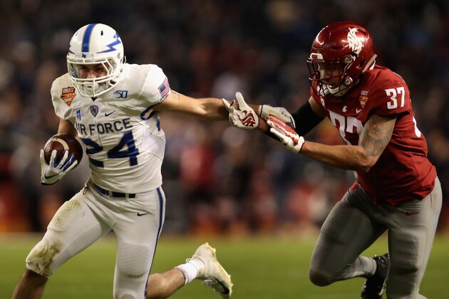 PHOENIX, ARIZONA - DECEMBER 27: Running back Kadin Remsberg #24 of the Air Force Falcons rushes the football past linebacker Justus Rogers #37 of the Washington State Cougars during the first half of the Cheez-It Bowl at Chase Field on December 27, 2019 in Phoenix, Arizona. (Photo by Christian Petersen/Getty Images)