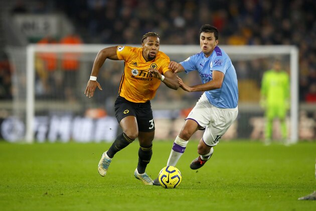 WOLVERHAMPTON, ENGLAND - DECEMBER 27: Adama Traore of Wolverhampton Wanderers competes with Rodrigo of Manchester City during the Premier League match between Wolverhampton Wanderers and Manchester City at Molineux on December 27, 2019 in Wolverhampton, United Kingdom. (Photo by Malcolm Couzens/Getty Images)
