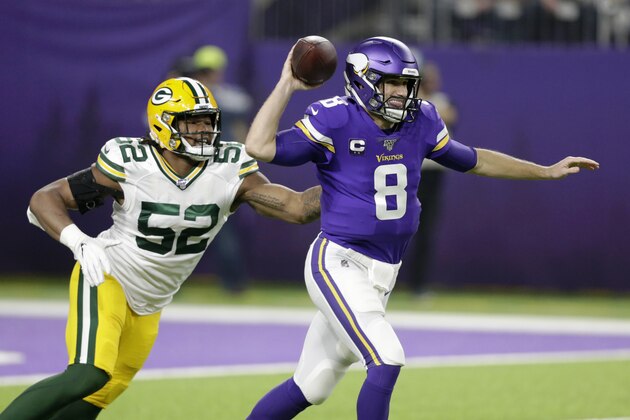 Minnesota Vikings quarterback Kirk Cousins throws a pass in front of Green Bay Packers linebacker Rashan Gary (52) during the first half of an NFL football game Monday, Dec. 23, 2019, in Minneapolis. (AP Photo/Andy Clayton-King)