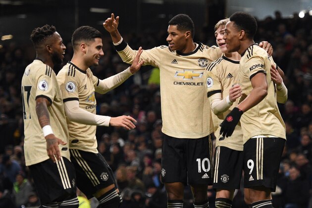 Manchester United's French striker Anthony Martial (R) celebrates scoring the opening goal with team-mates (L-R) Manchester United's Brazilian midfielder Fred, Manchester United's Belgian-born Brazilian midfielder Andreas Pereira, Manchester United's English striker Marcus Rashford and Manchester United's English defender Brandon Williams during the English Premier League football match between Burnley and Manchester United at Turf Moor in Burnley, north west England on December 28, 2019. (Photo by Oli SCARFF / AFP) / RESTRICTED TO EDITORIAL USE. No use with unauthorized audio, video, data, fixture lists, club/league logos or 'live' services. Online in-match use limited to 120 images. An additional 40 images may be used in extra time. No video emulation. Social media in-match use limited to 120 images. An additional 40 images may be used in extra time. No use in betting publications, games or single club/league/player publications. /  (Photo by OLI SCARFF/AFP via Getty Images)