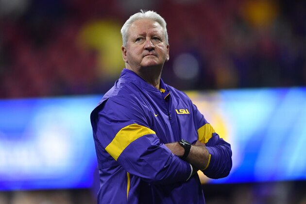 LSU Offensive Coordinator Steve Ensminger watches teams warm up before the first half of the Peach Bowl NCAA semifinal college football playoff game between LSU and Oklahoma, Saturday, Dec. 28, 2019, in Atlanta. Ensminger's daughter-in-law, Carley McCord, died in a plane crash Saturday in Louisiana on the way to the game. (AP Photo/John Amis)