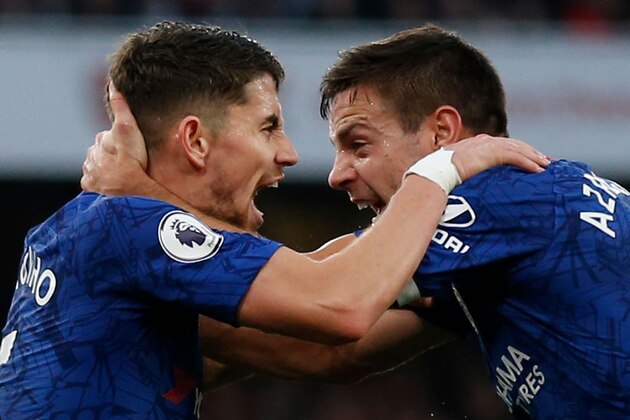 Chelsea's Italian midfielder Jorginho (L) celebrates scoring their first goal to equalise 1-1 with Chelsea's Spanish defender Cesar Azpilicueta (R) during the English Premier League football match between Arsenal and Chelsea at the Emirates Stadium in London on December 29, 2019. (Photo by Ian KINGTON / IKIMAGES / AFP) / RESTRICTED TO EDITORIAL USE. No use with unauthorized audio, video, data, fixture lists, club/league logos or 'live' services. Online in-match use limited to 45 images, no video emulation. No use in betting, games or single club/league/player publications. (Photo by IAN KINGTON/IKIMAGES/AFP via Getty Images)